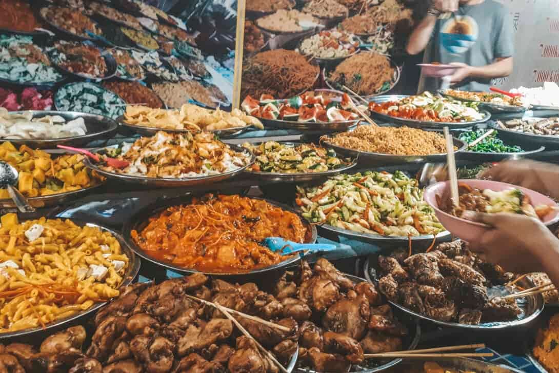 Must-try Asian street food dishes including som tum, pho, char kway teow, and takoyaki