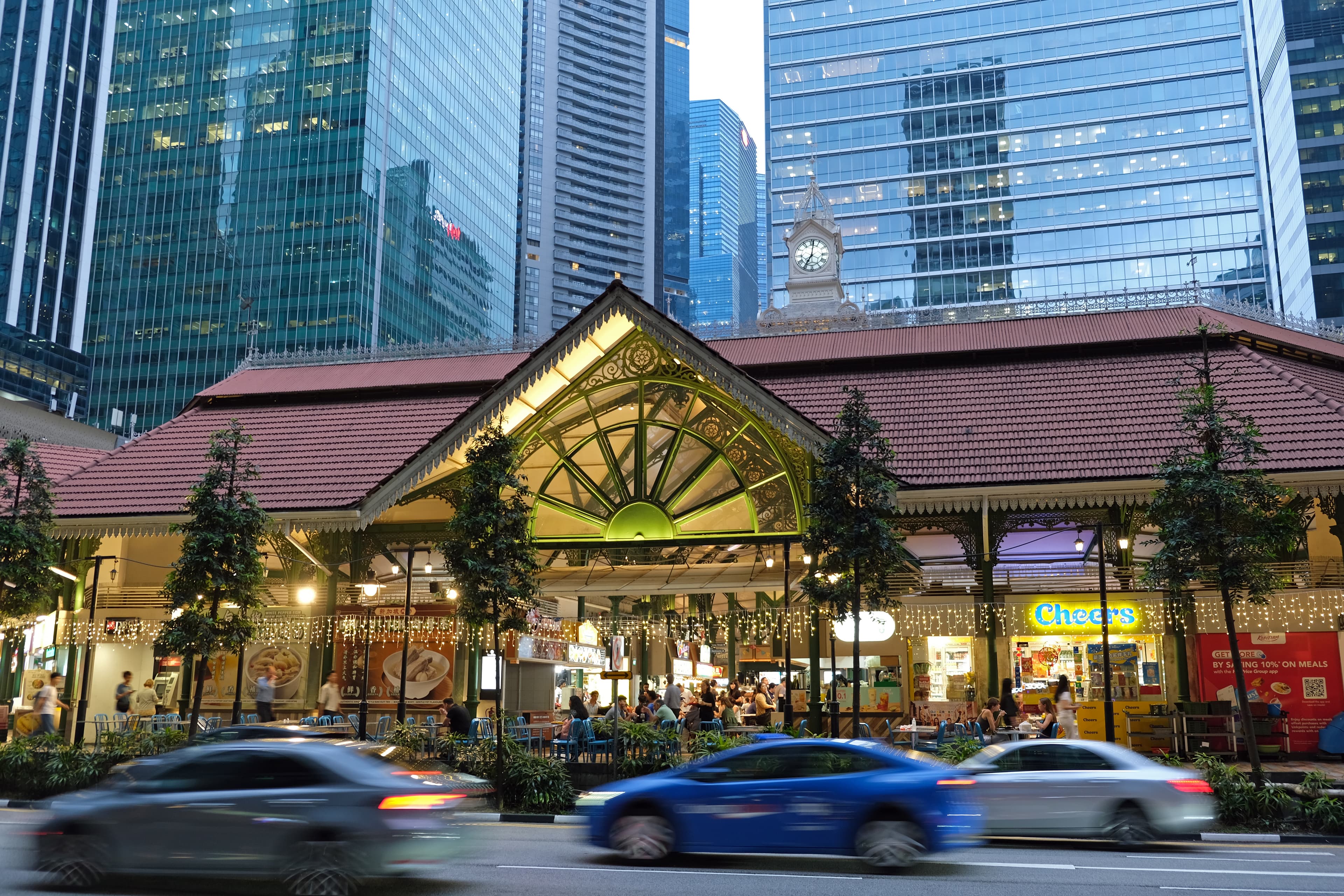Exterior view of Lau Pa Sat, a historic food market in Singapore, featuring its distinctive octagonal structure and urban surroundings
