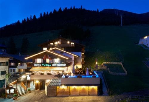 Traditional alpine hotel building facade in the village of Malbun with wooden accents