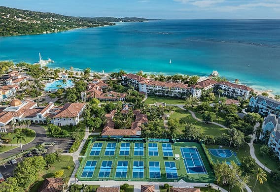 Seven Mile Beach in Negril, Jamaica, showing the coastline and clear blue sea from an elevated perspective