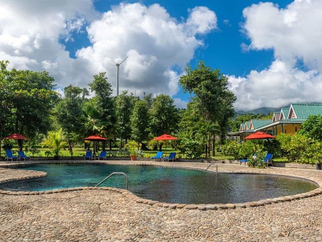 Exterior of the Rosalie Bay Eco Resort & Spa, showing open-air architecture blending with the rainforest