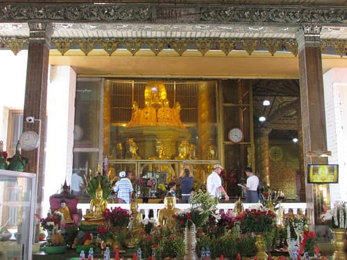 Chauk Taw Street teahouse exterior with wooden architecture and local life in Mudon, Myanmar