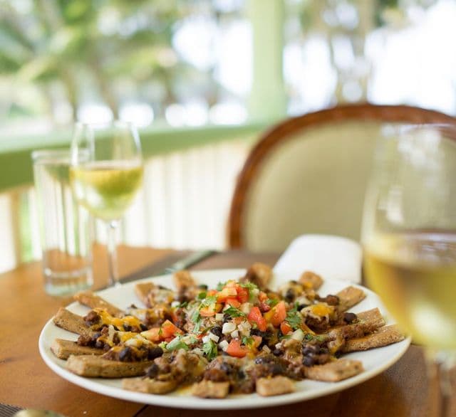Platter of fresh tropical fruits and local produce on a dining table at an eco-resort in Rosalie, Dominica