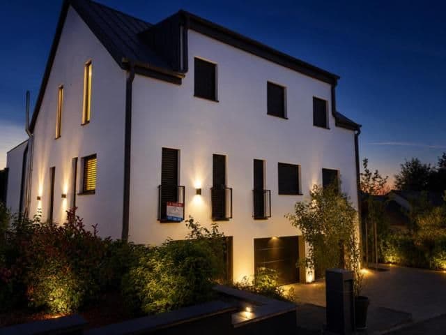 Building exterior with illuminated windows at dusk