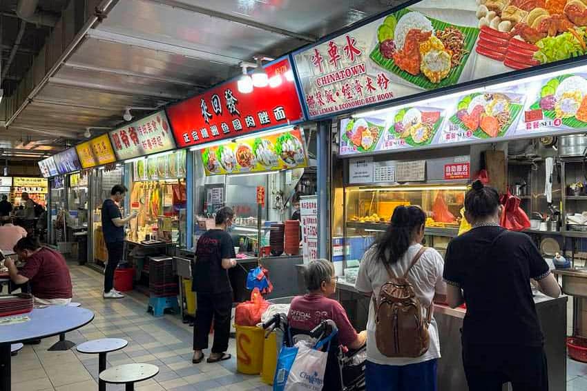 Exterior of the Chinatown Complex Food Centre in Singapore, showcasing its multi-level structure and bustling entrance