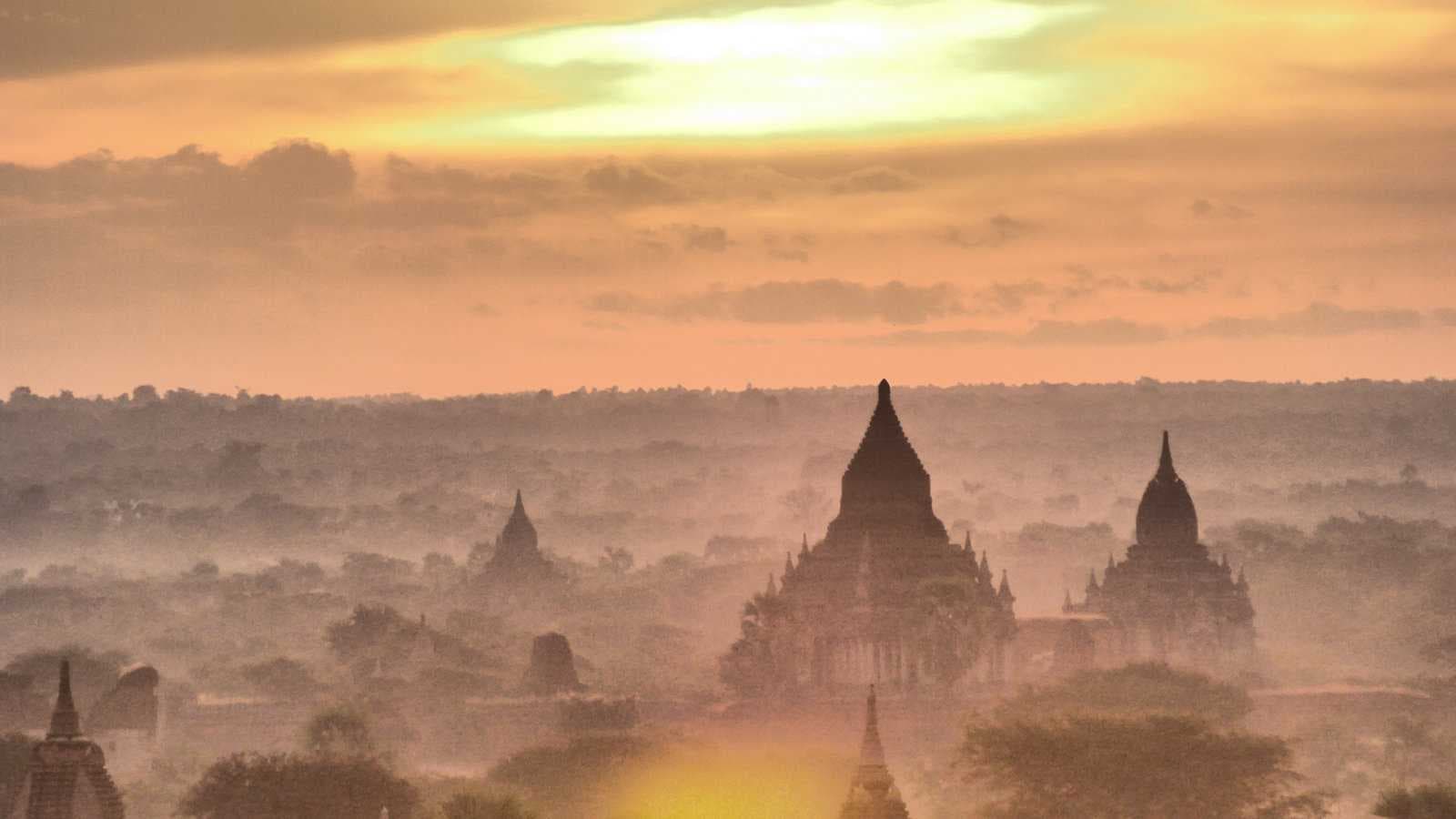 Dawn light illuminating thousands of Buddhist temples and stupas across the plains of Bagan, Myanmar