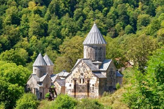 Traditional rural homestay building exterior beside a river in Artashat, Armenia