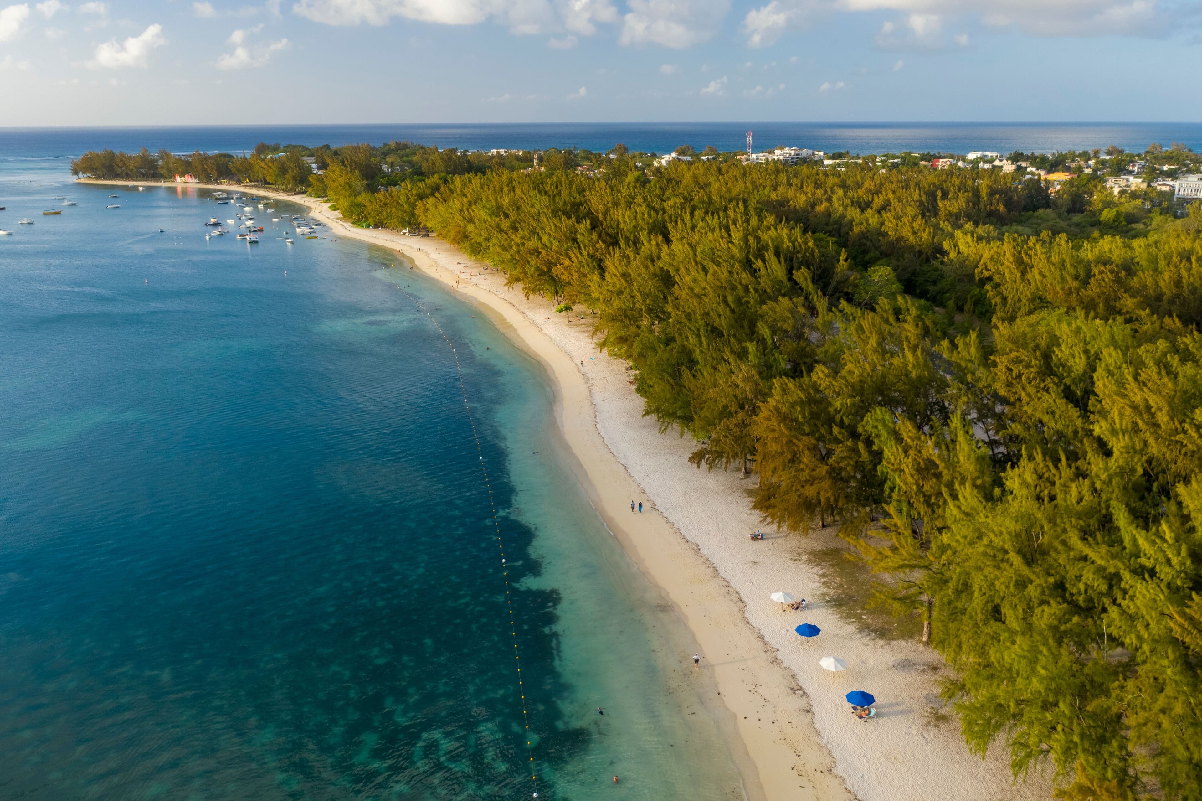 Aerial view of Fond du Sac bay showing turquoise waters, a sandy beach, and dense green vegetation along the coastline.
