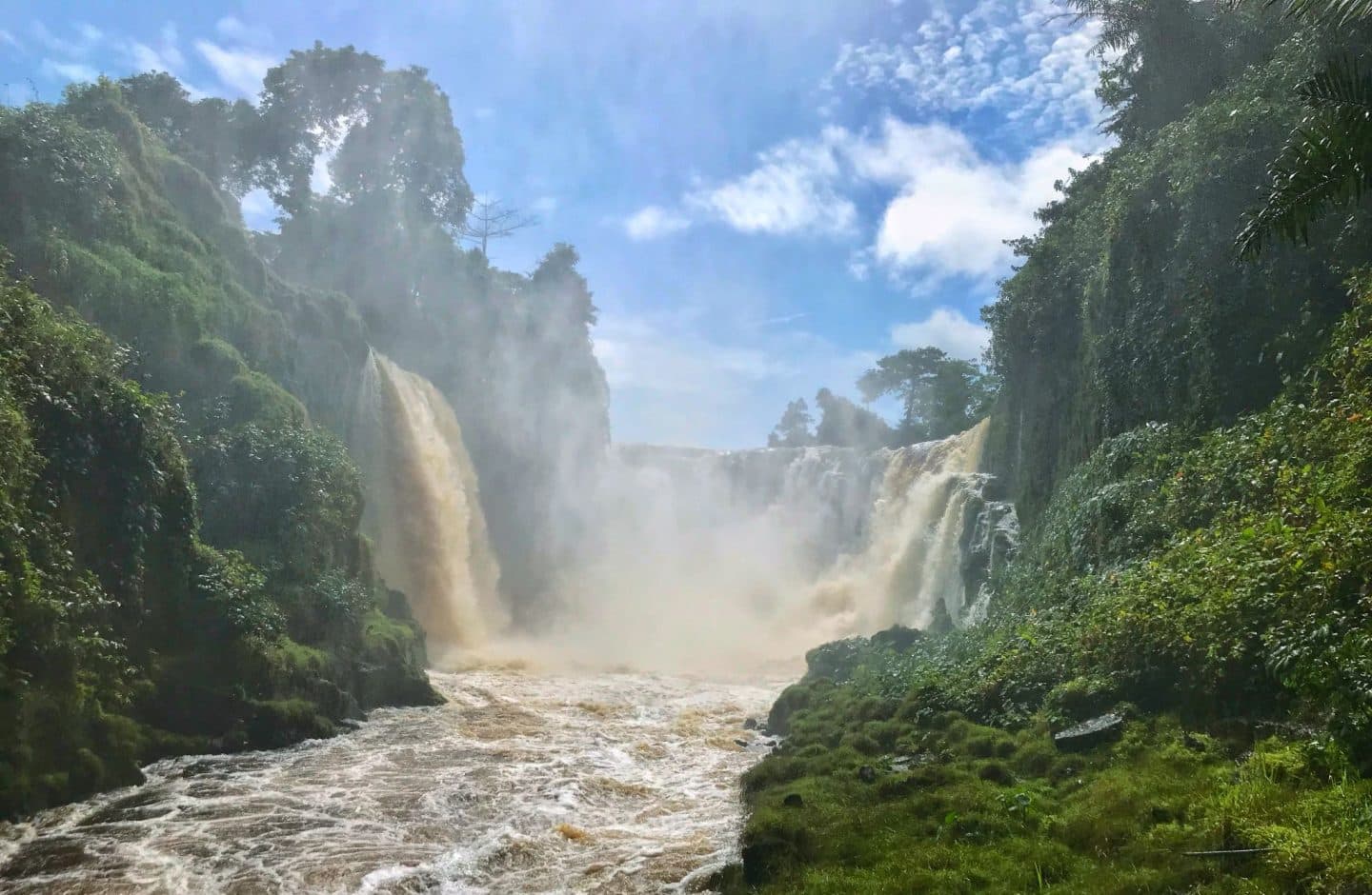 Waterfall cascading through lush green rainforest in Gabon
