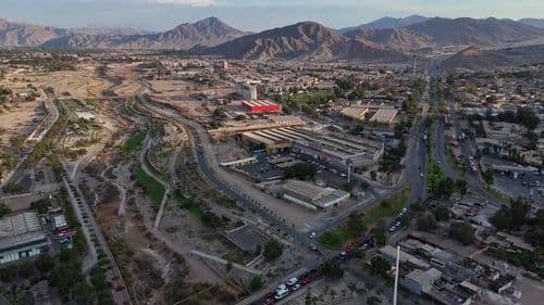 Aerial view of a city street and avenue scene in Copiapó, showing roads, buildings, and surrounding mountains