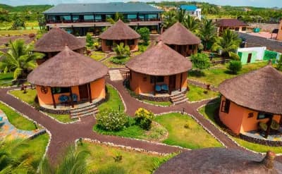 Facade of Lemon Beach Resort and nearby accommodations in Elmina, Ghana