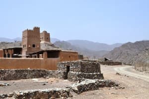 Streetscape of traditional Omani village with stone houses and narrow pathways