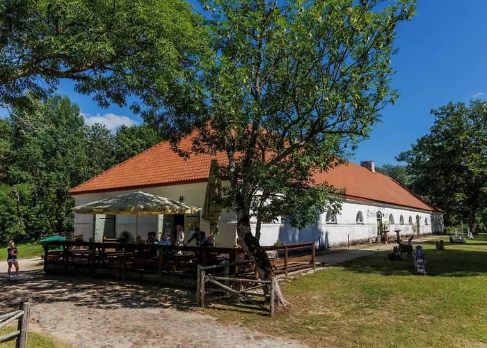 Palmse Guesthouse exterior in Haljala vald, Estonia, showing a rural farmhouse with garden during spring