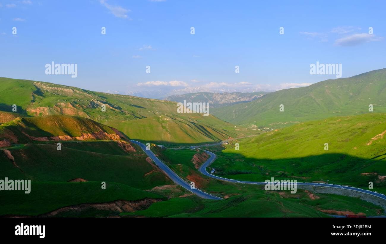 Aerial panorama of high mountain passes and valleys in Central Asia, near the Tajikistan border, during spring