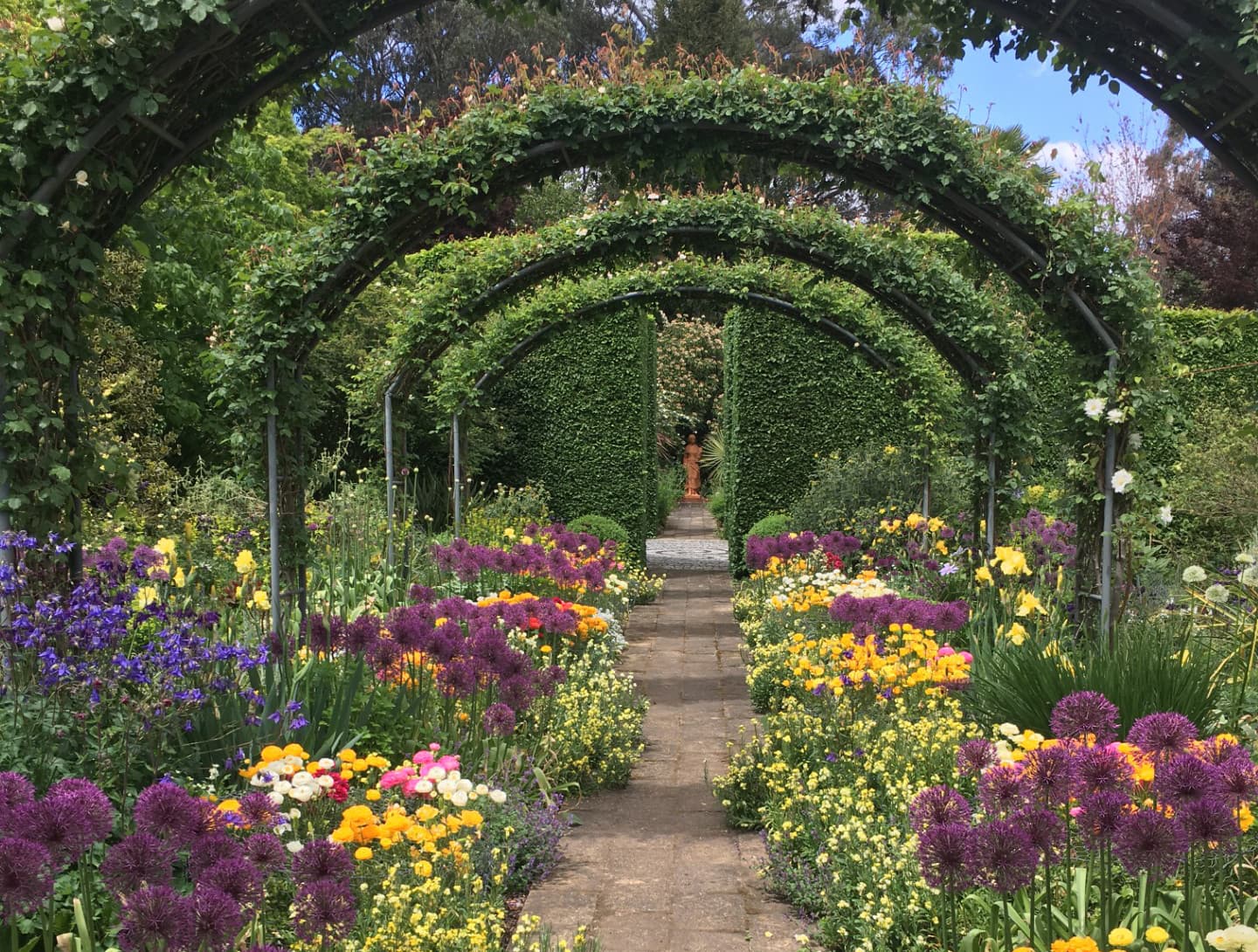 Sunnymeade Garden in Strathbogie with colorful flowers, topiary, and ponds