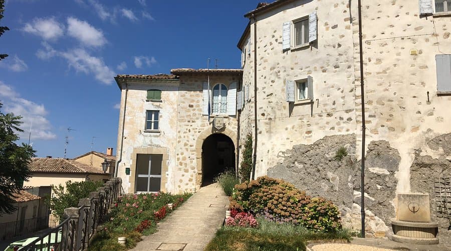 Stone exterior of a historic hotel building in Montegiardino, San Marino, featuring traditional architecture