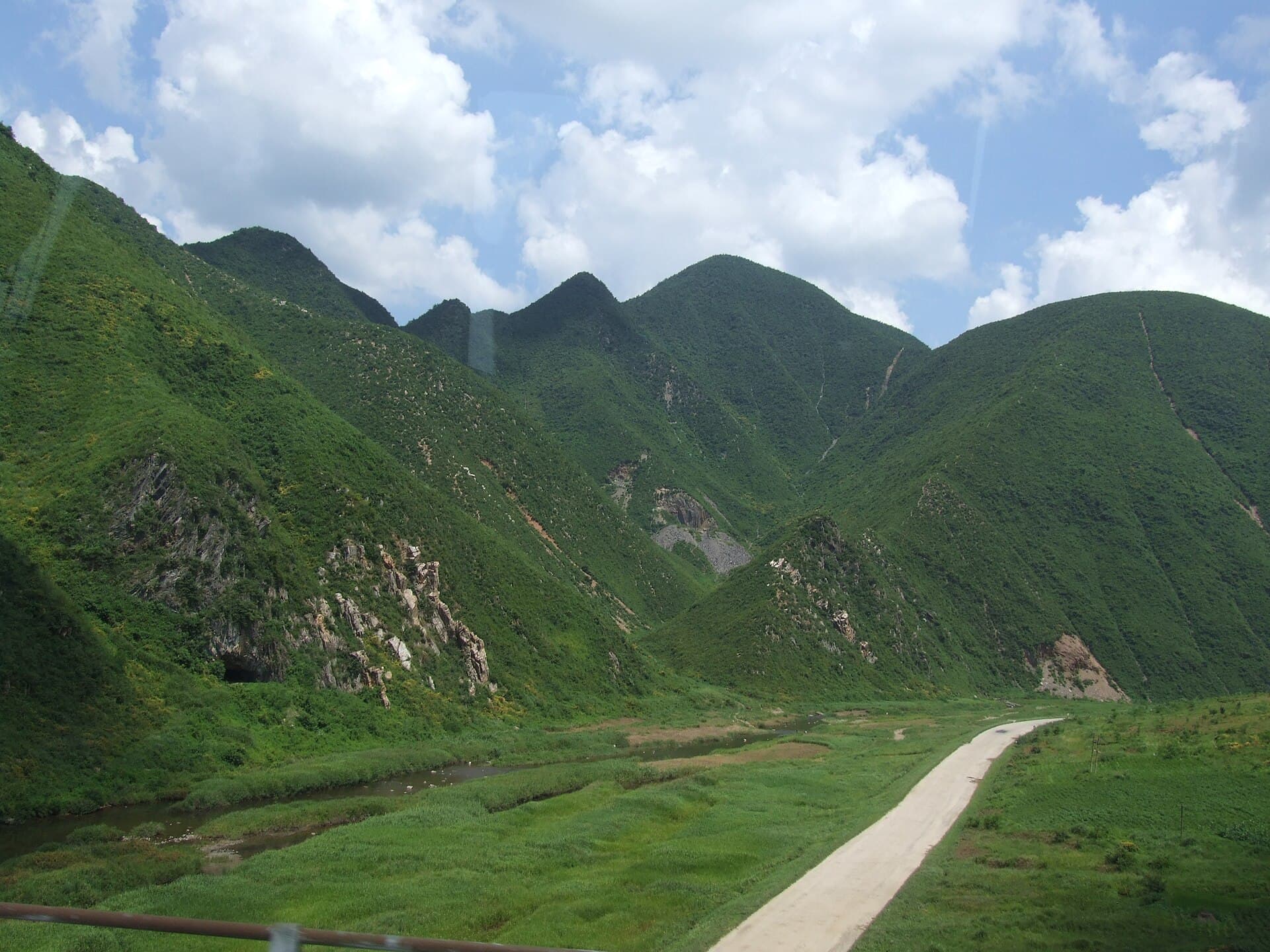 Lush green mountains and winding valley road in Kangwon Province, North Korea