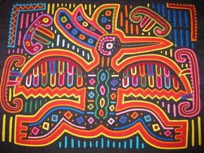 Close-up of a colorful Ngabe mola textile featuring intricate appliqué patterns and vibrant geometric designs.