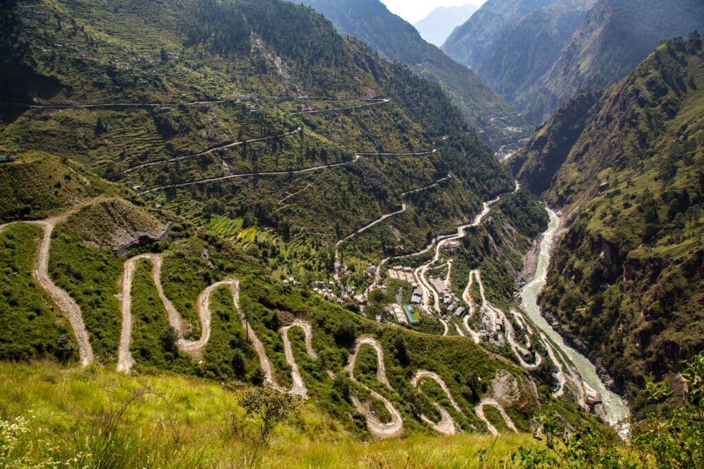 The challenging road network approaching Joshimath, Uttarakhand, characterized by steep gradients and narrow passages through the Himalayas.