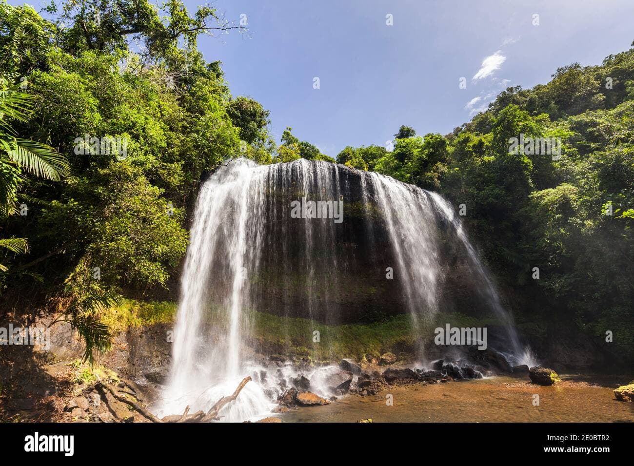 Waterfall cascading down a cliff face in the deep rainforest of Ngardmau, Palau
