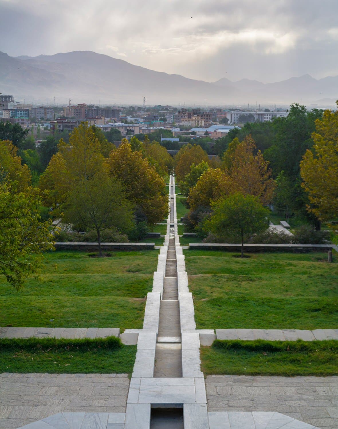 Landscape view of Babur Gardens in Kabul, Afghanistan during spring 2026, showing pathways and natural scenery