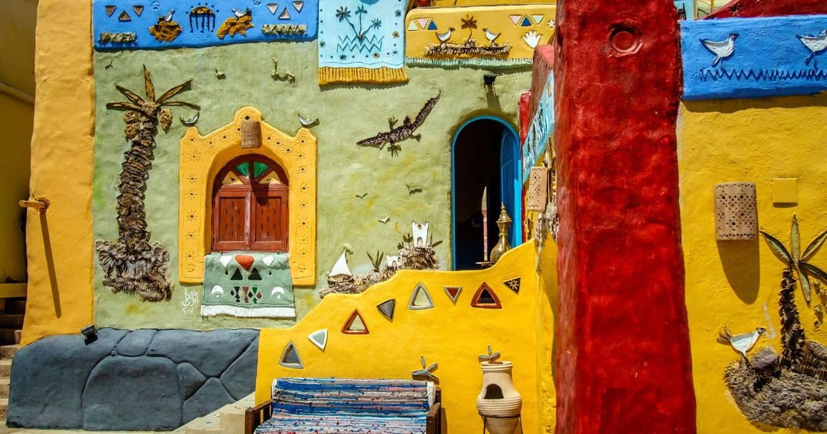Colorful Nubian village architecture with painted walls, decorative motifs, and traditional doors in Sudan.