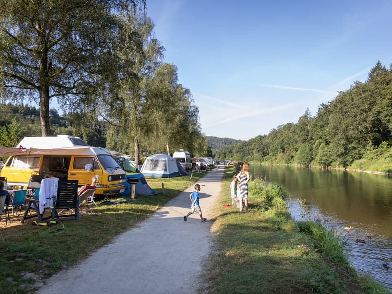 River Ourthe in La Roche-en-Ardenne, Belgium, with stone walls and buildings along the riverbank