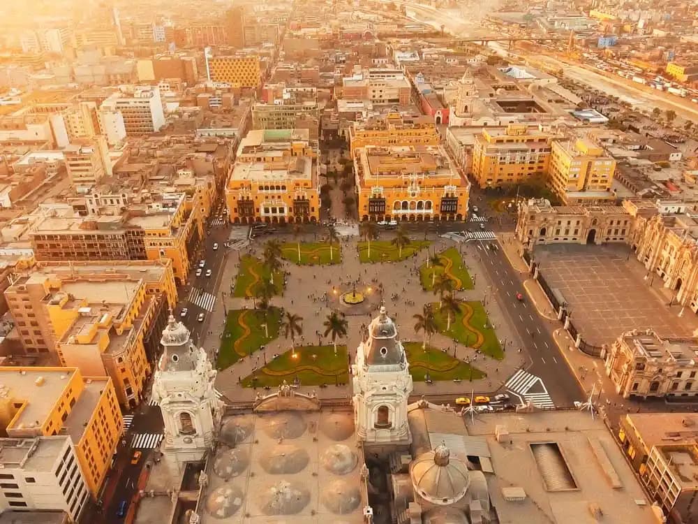 Rooftop bar with panoramic view of Lima's cityscape and historic buildings