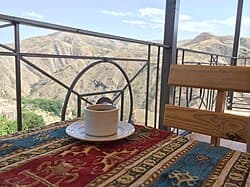 Close-up of Armenian coffee cup and traditional sweets on a wooden table