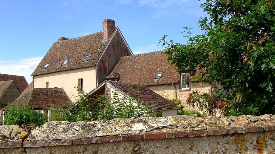Stone facade of Domaine du Tronchay in Courville-sur-Eure, France, during spring