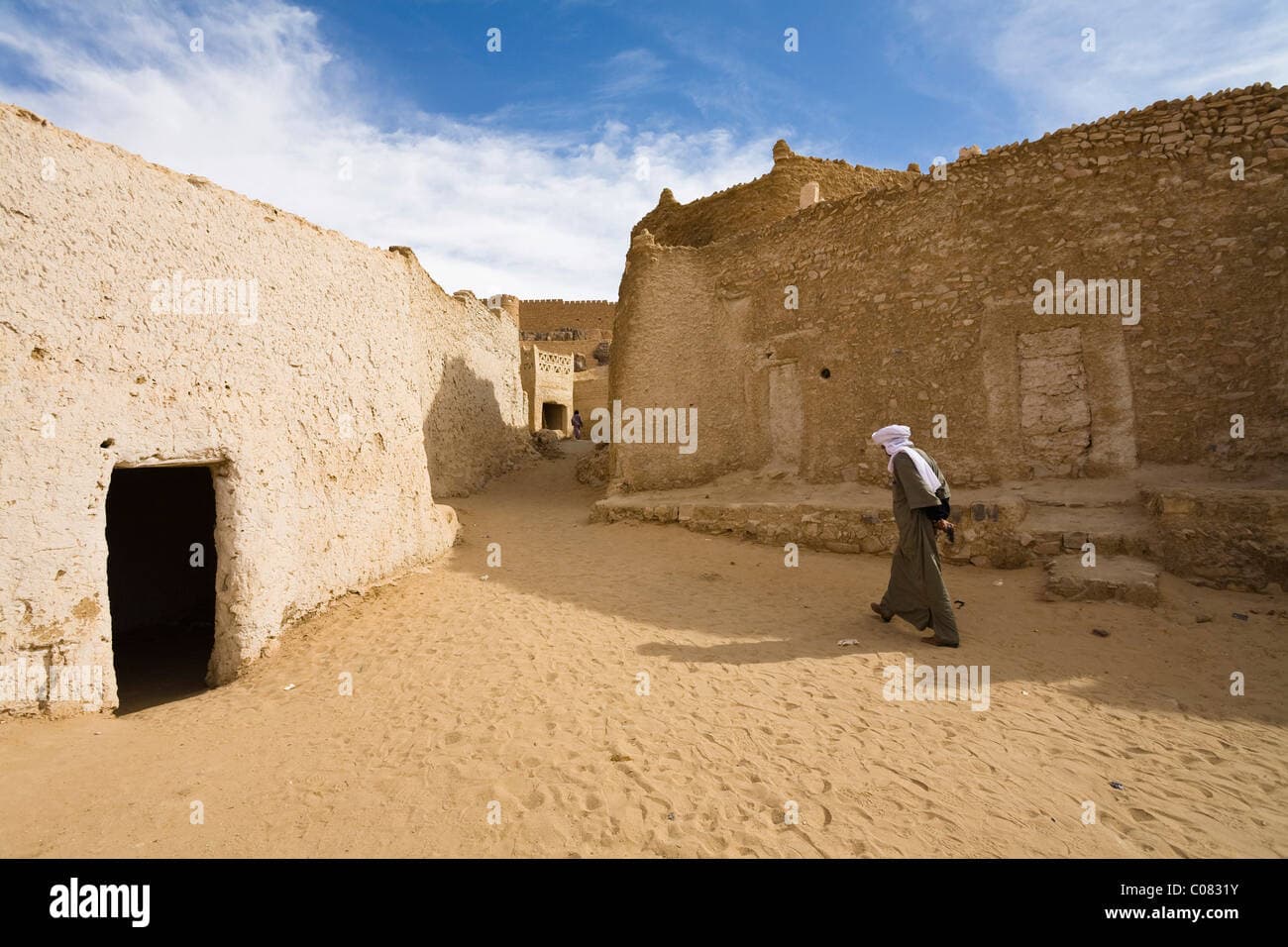 Traditional Berber architecture in Ghat, Libya, featuring clustered clay buildings nestled against rocky cliffs