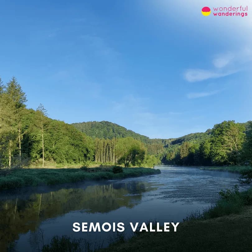 Wide view of the Semois Valley in La Roche-en-Ardenne, Belgium, featuring the river and surrounding green hills in spring