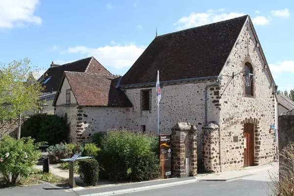 Spring view of Courville-sur-Eure village center with historic stone buildings and cobbled streets