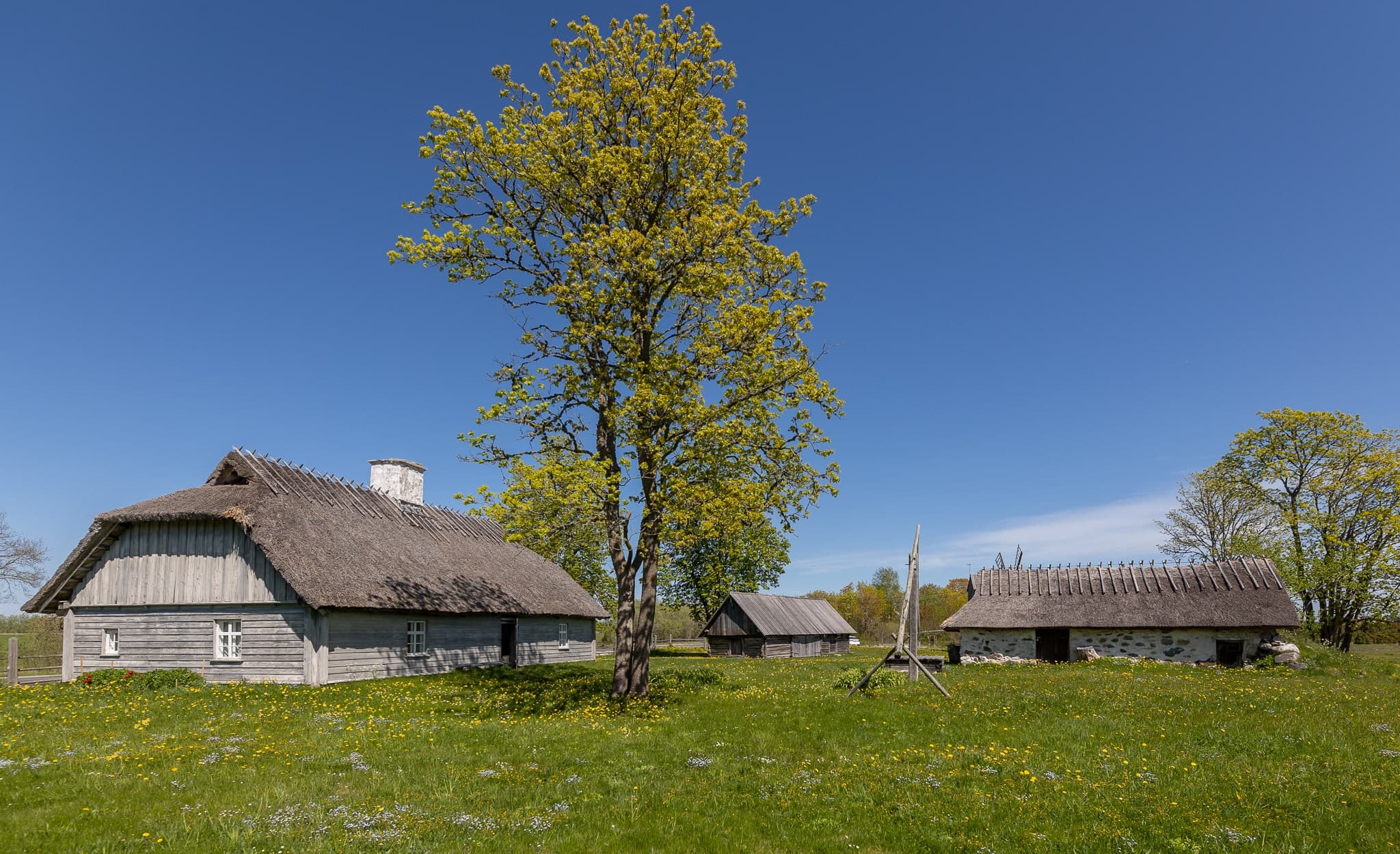 Establishing shot of Kadrina Church in Estonia, a modest 19th-century stone church with bell tower visible against the sky