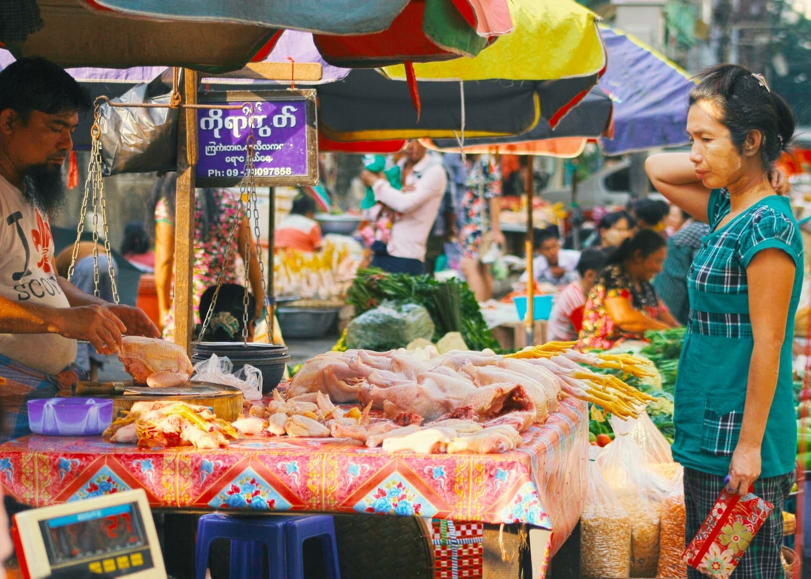 Outdoor food stalls and market activity in a Myanmar town