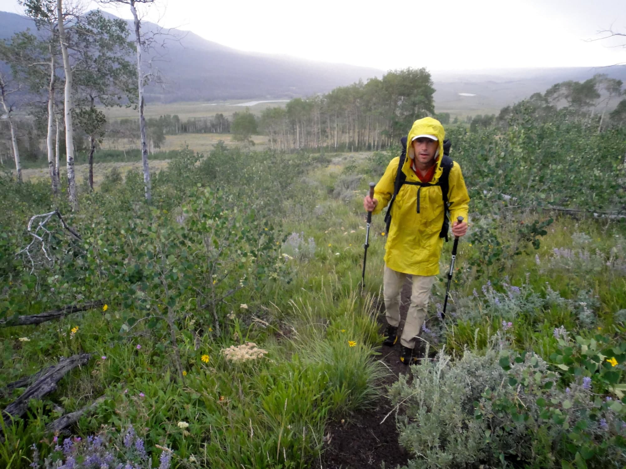 Hiking rain jacket and backpack laid out for a spring trek in Scotland