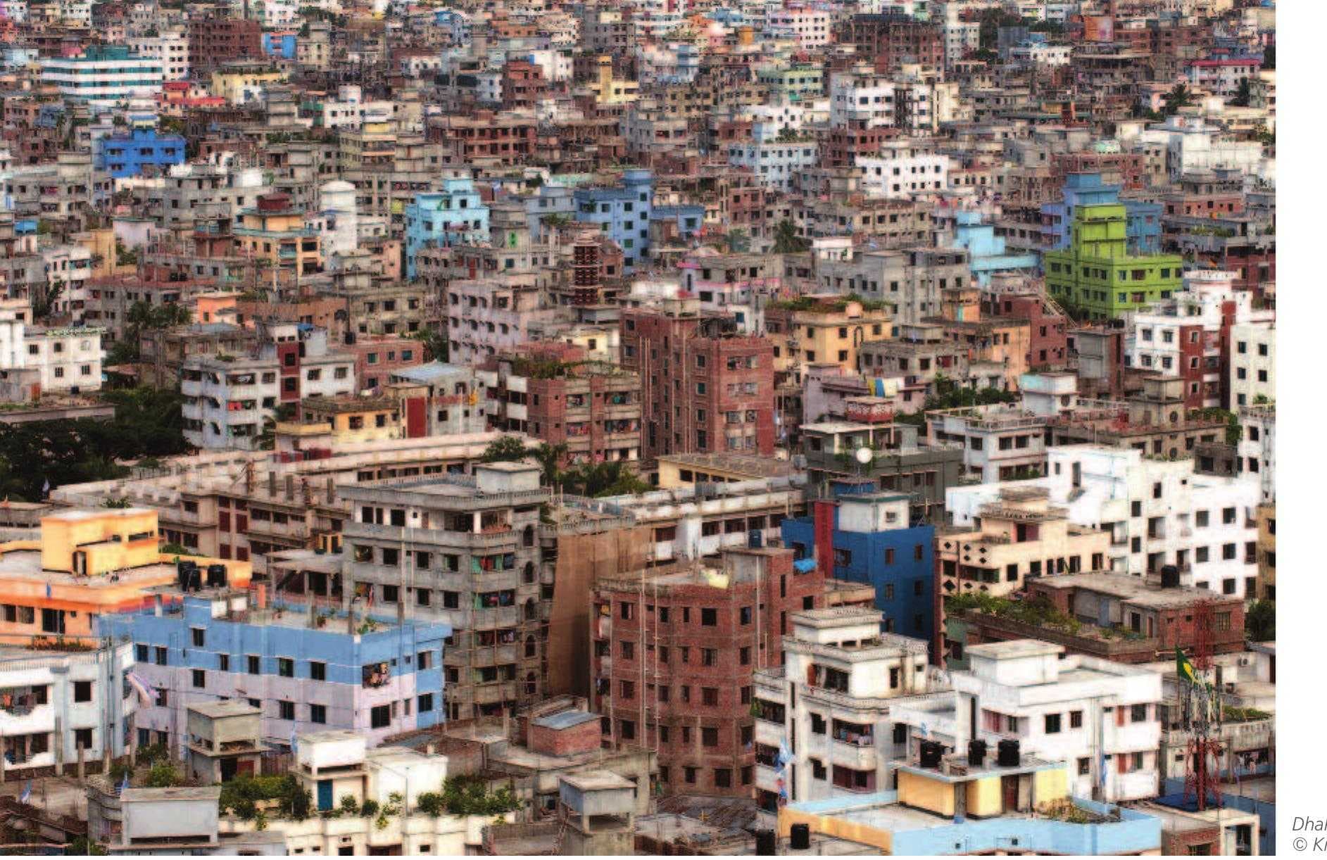 Aerial view of a dense urban area with colorful buildings, typical of a coastal town's architecture in Newala District, Tanzania.