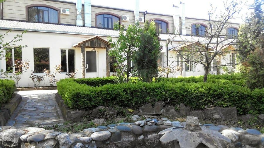 Stone facade of a traditional Armenian mountain lodge with wooden balconies
