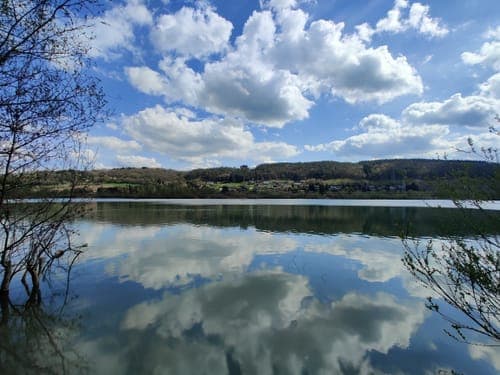 Wide landscape view of the Meuse River gorge and surrounding cliffs in Amay, Belgium