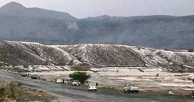Mountain road with vehicles winding through highland passes toward Wadi Al Ayn, Yemen.